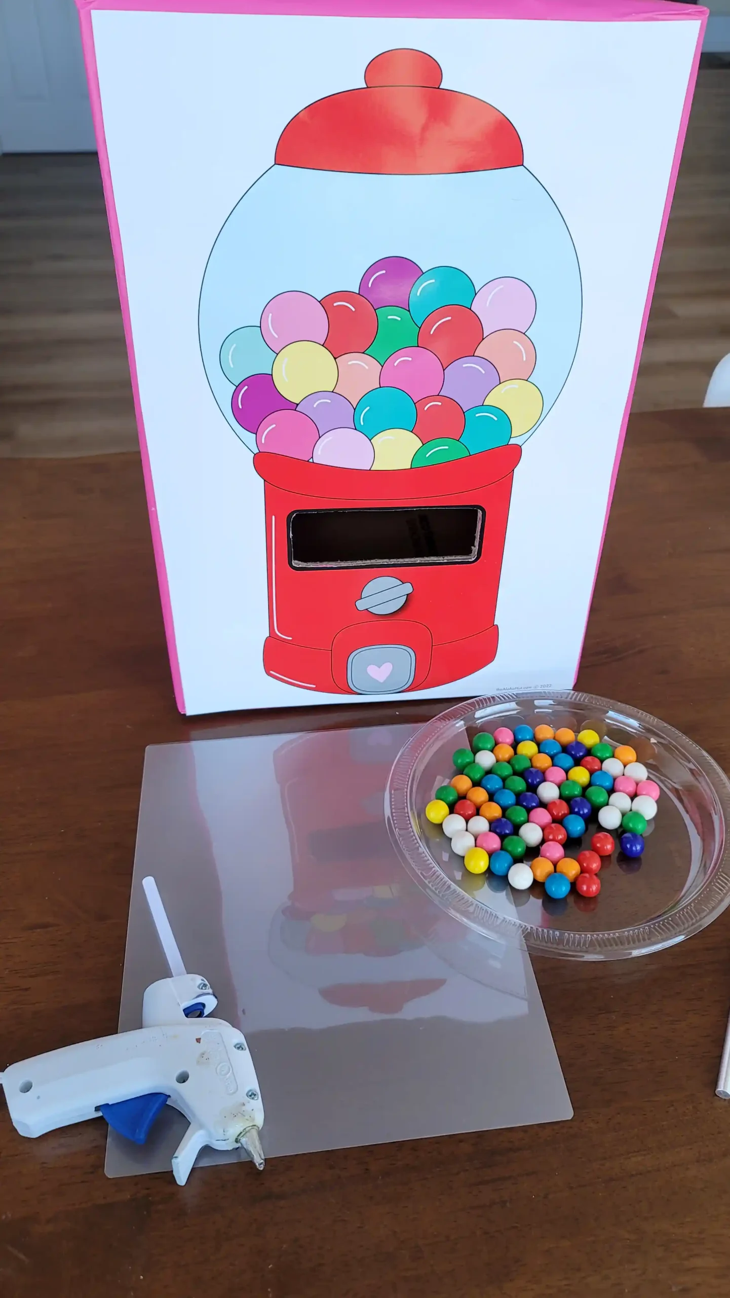 How to make a Valentine's Day gumball machine box for kids. Includes step by step instruction with a printable red or pink gumball machine, all the supplies you need to make a DIY homemade valentine box!